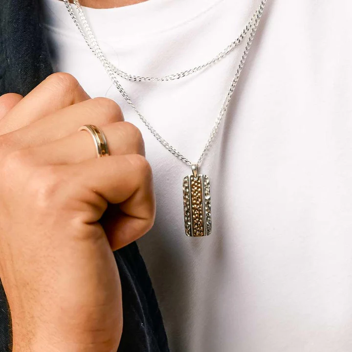 Man wears gold and silver necklace 